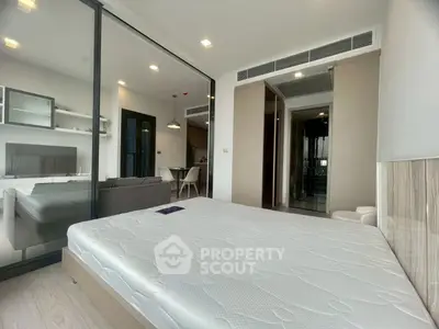 Modern apartment interior with spacious bedroom and living area, featuring sleek design and ample natural light.