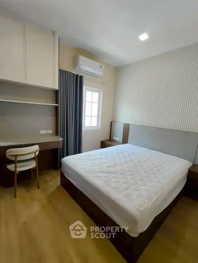 Modern bedroom with minimalist design, featuring a cozy bed, study desk, and ample natural light.