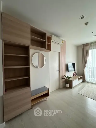 Modern living room with stylish wooden shelving and wall-mounted TV