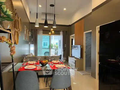Modern dining and living area with stylish decor and natural light