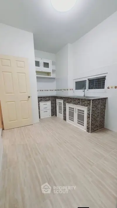 Spacious kitchen with modern cabinetry and tiled backsplash