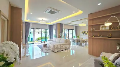 Luxurious open-plan living room with elegant decor and large windows offering stunning views.