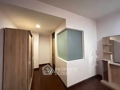 Modern hallway with wooden flooring and built-in wardrobe