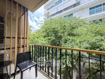Charming balcony with lush green view in modern apartment complex