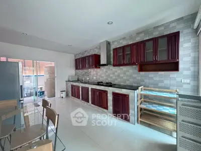 Spacious modern kitchen with sleek cabinetry and open layout, perfect for culinary enthusiasts.