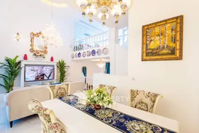 Luxurious open-plan living and dining area with elegant decor and high ceilings