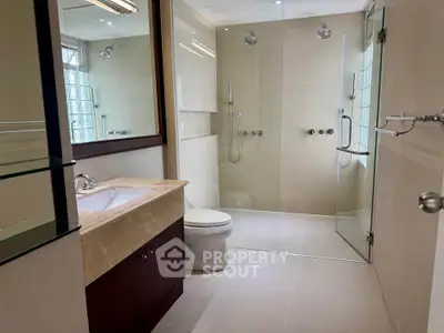 Spacious modern bathroom with glass shower and elegant fixtures
