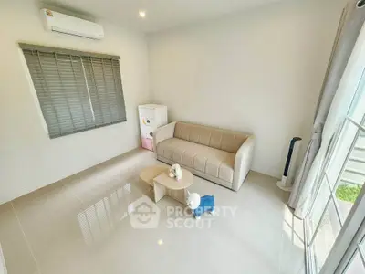 Modern minimalist living room with beige sofa and air conditioning