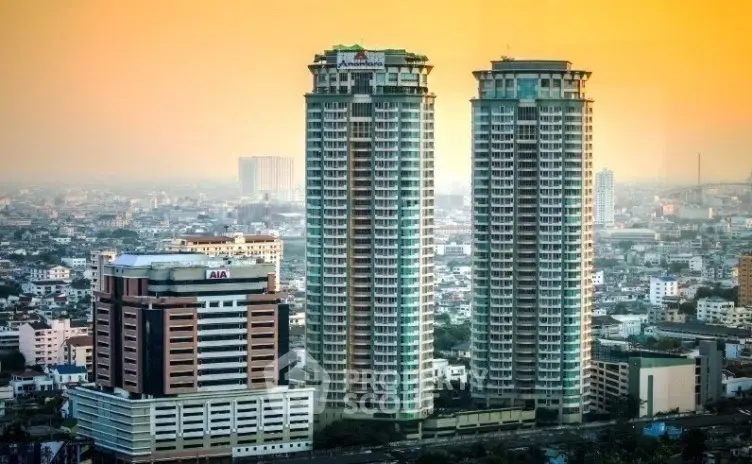 Stunning cityscape view featuring twin high-rise residential towers at sunset.