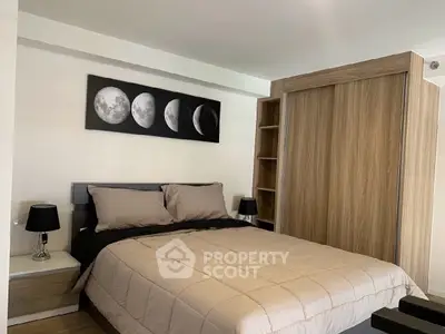 Modern bedroom with stylish decor and wooden wardrobe in a cozy apartment.