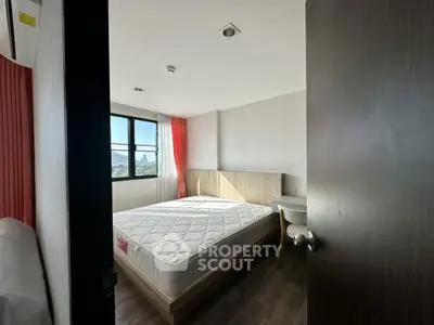 Bright bedroom with large window and modern furnishings