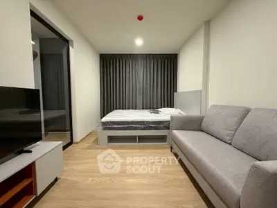 Modern studio apartment with cozy living area and stylish furnishings.