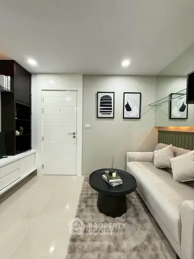 Modern living room with sleek design, cozy sofa, and stylish decor in a contemporary apartment.