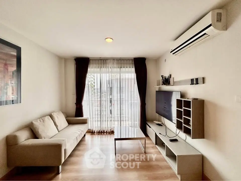 Modern living room with stylish furniture and natural light from large windows.