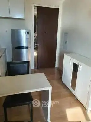 Compact kitchen with modern appliances and dining area
