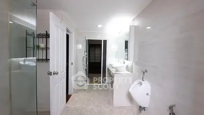 Spacious modern bathroom with sleek fixtures and ample lighting