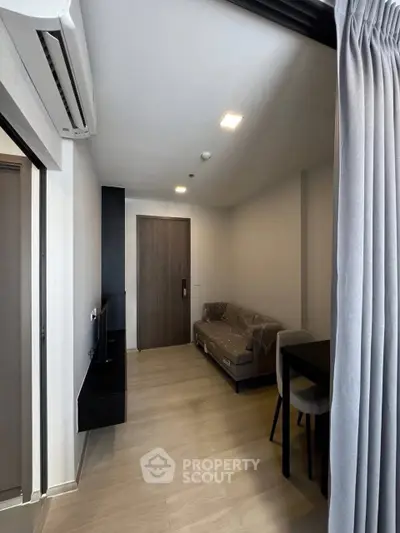 Modern living room with sleek design and air conditioning in a cozy apartment.