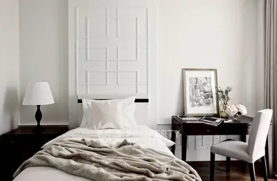 Elegant bedroom with modern decor, featuring a cozy bed, stylish desk, and chic lighting.