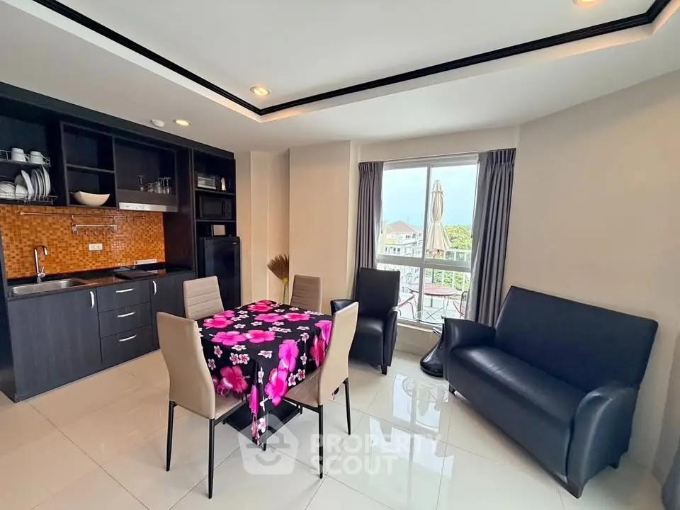 Modern living room with open kitchen and balcony view