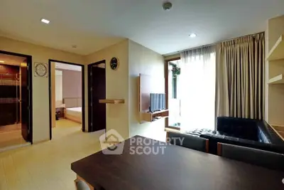 Modern living room with natural light, sleek furniture, and open layout in a stylish apartment.