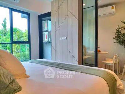 Modern bedroom with large windows and stylish decor in a serene setting