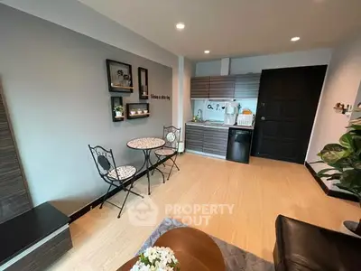 Charming open-layout living room with modern kitchenette and stylish decor