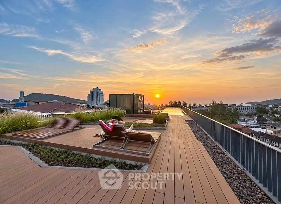 Stunning rooftop terrace with sunset view and modern lounge chairs