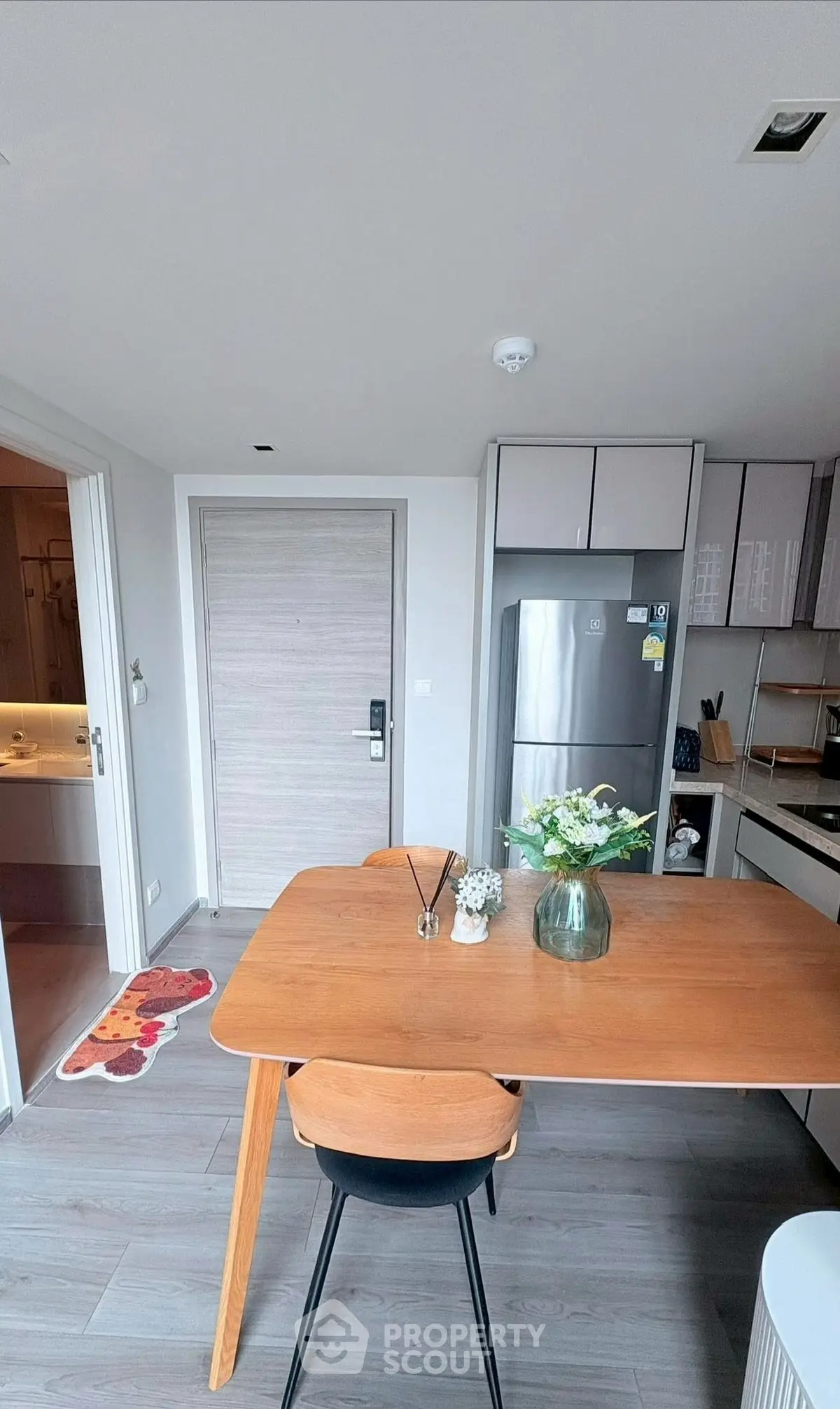 Modern kitchen with sleek design and stainless steel appliances in a cozy apartment.