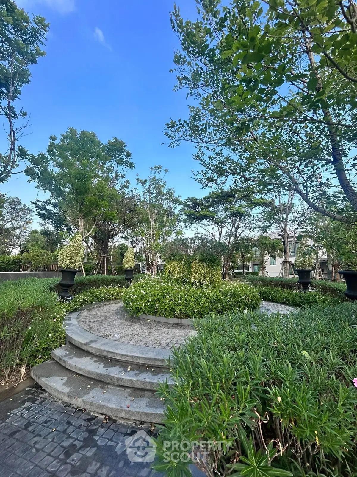 Luxurious garden with lush greenery and elegant landscaping in a serene residential setting.