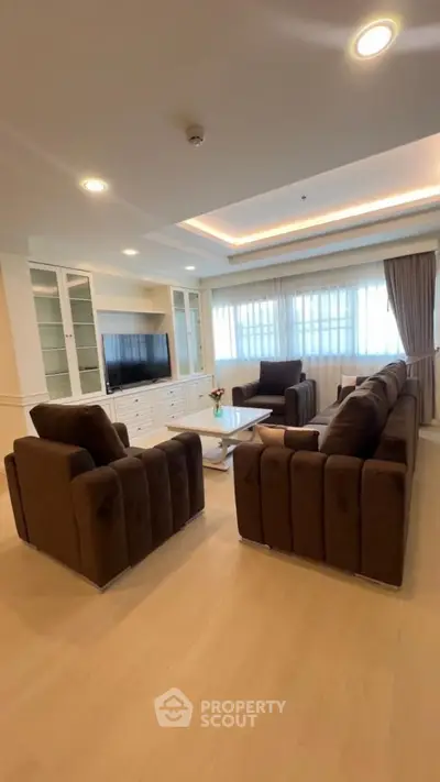 Spacious living room with plush sofas and modern decor, perfect for relaxation and entertainment.