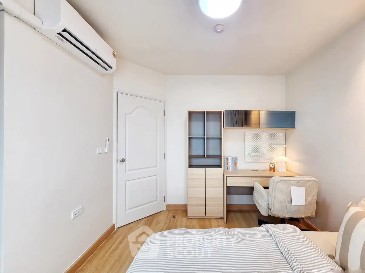 Cozy bedroom with study area and modern furniture, perfect for comfortable living.
