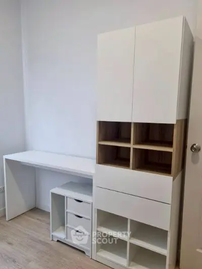 Modern study room with sleek white desk and storage unit