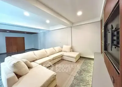 Spacious modern living room with plush sectional sofa and sleek design.