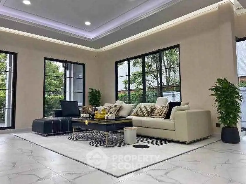 Spacious modern living room with large windows and elegant decor