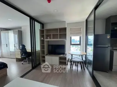 Modern apartment interior with open layout, featuring a cozy living area and city view.