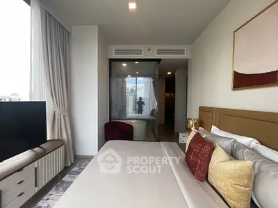Luxurious bedroom with modern decor and city view, featuring a cozy bed and elegant furnishings.