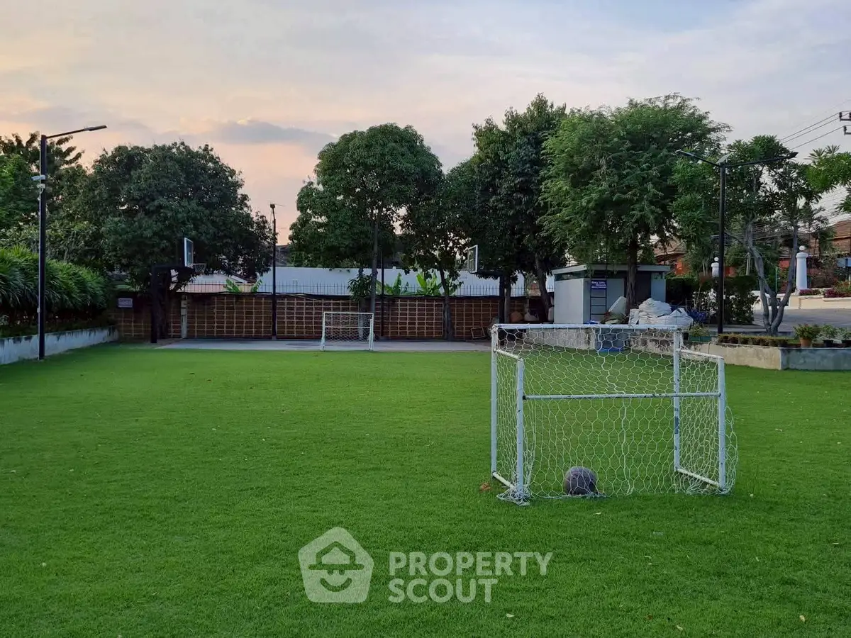 Spacious green garden area with small soccer goals, perfect for outdoor activities and relaxation.