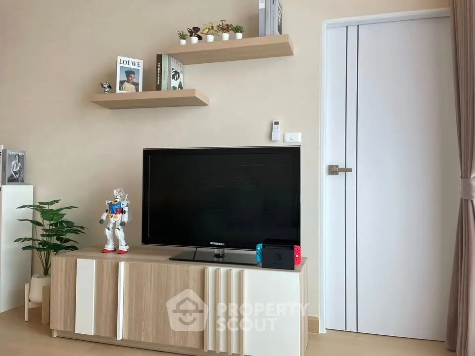 Modern living room with sleek TV stand, stylish shelves, and contemporary decor.