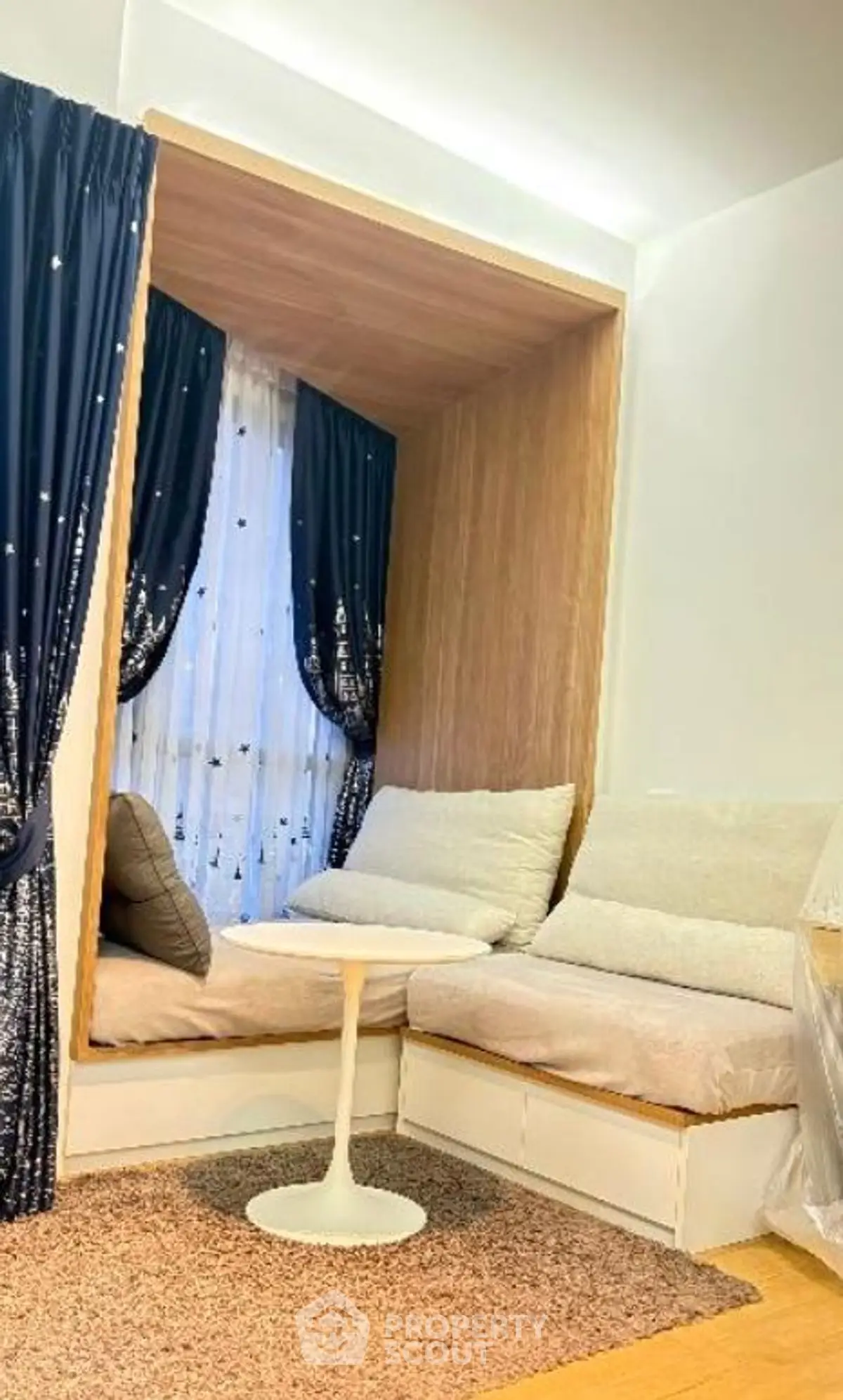 Cozy reading nook with plush seating and elegant curtains in modern home