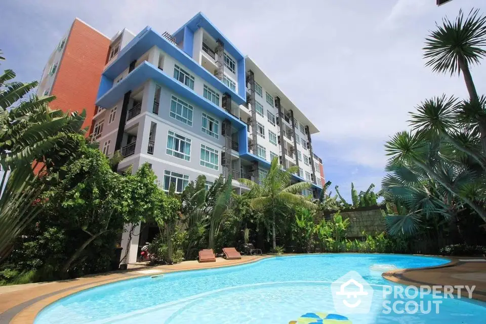 Modern condominium with lush garden and inviting swimming pool, perfect for relaxation and leisure.