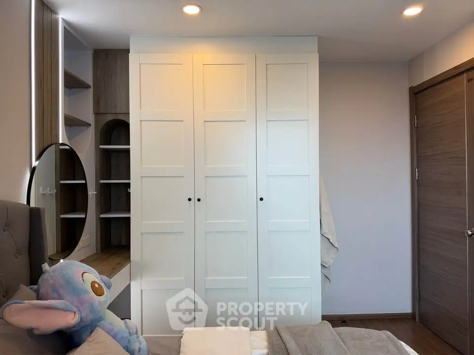 Cozy bedroom with modern wardrobe and plush decor