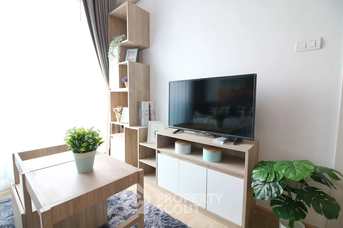 Modern living room with stylish wooden furniture and large TV, perfect for cozy relaxation.