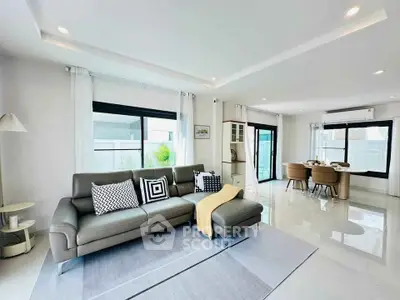 Spacious modern living room with sleek furniture and large windows