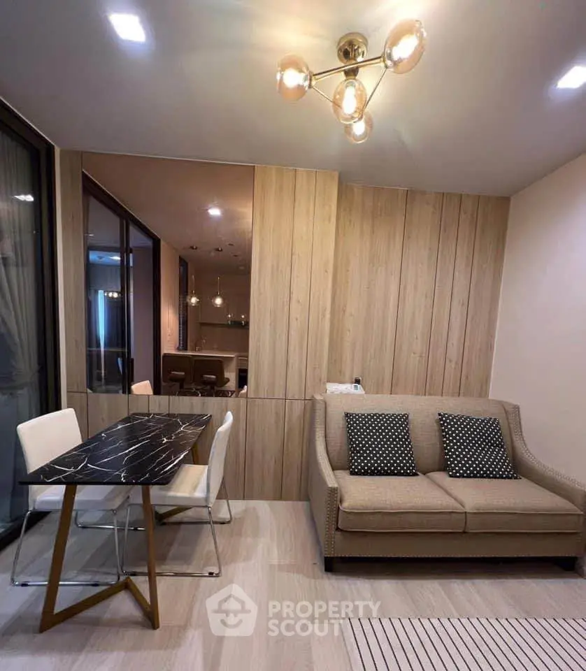 Modern living room with stylish furniture and elegant lighting in a cozy apartment setting.