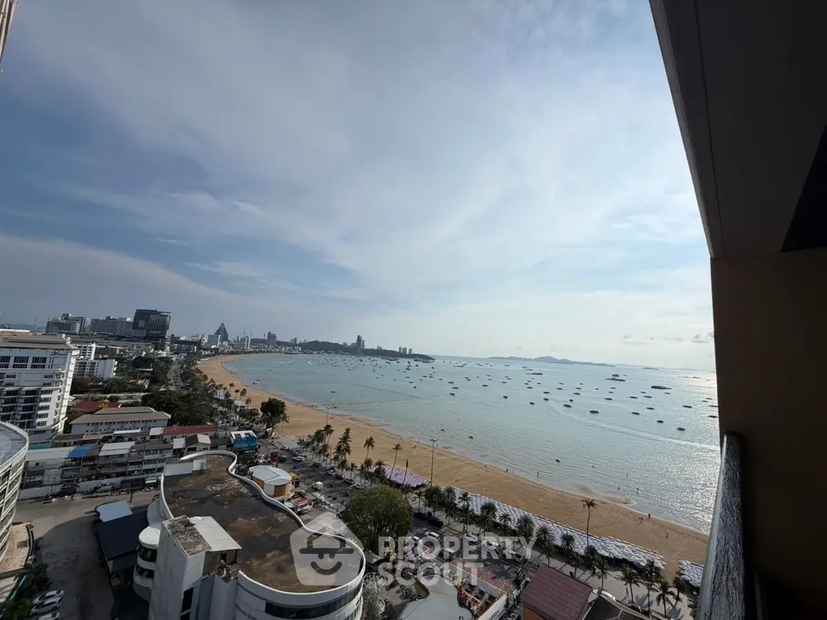 Stunning beachfront view from high-rise building overlooking ocean and cityscape.