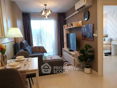 Modern living room with stylish decor and open layout leading to bedroom