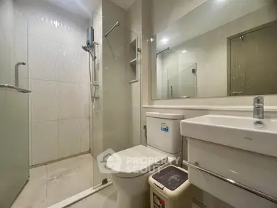 Modern bathroom with sleek fixtures and glass shower enclosure