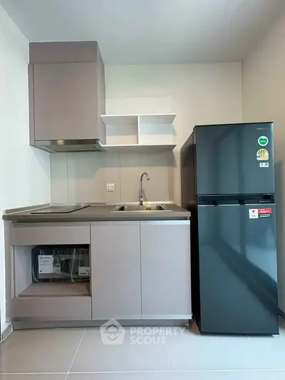Modern kitchen with sleek cabinetry and stainless steel appliances in a contemporary apartment.