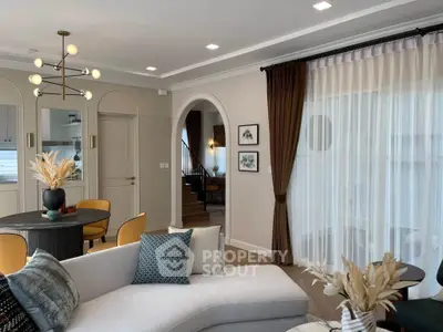 Elegant living room with modern decor, stylish lighting, and cozy seating area, perfect for relaxation.