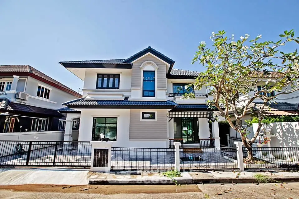 Stunning two-story modern house with elegant facade and spacious front yard.